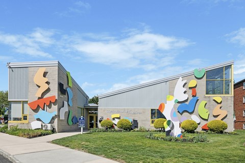 A colorful building with a mural on the side.