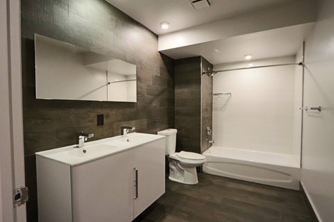 A bathroom with a toilet, sink, and bathtub.