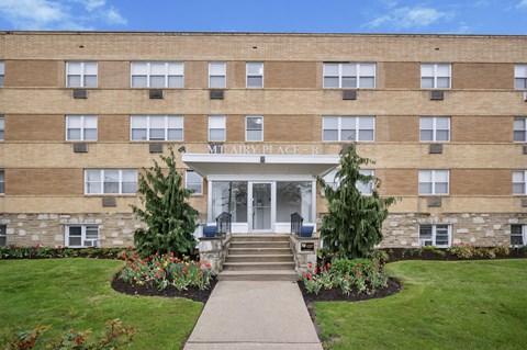 A brick building with a sign that says "Military Place" on it.