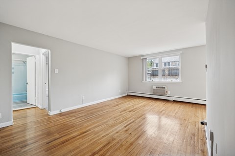 A room with wooden floors and white walls.