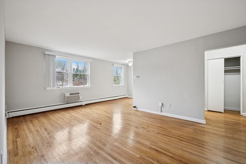 A room with wooden floors and white walls.