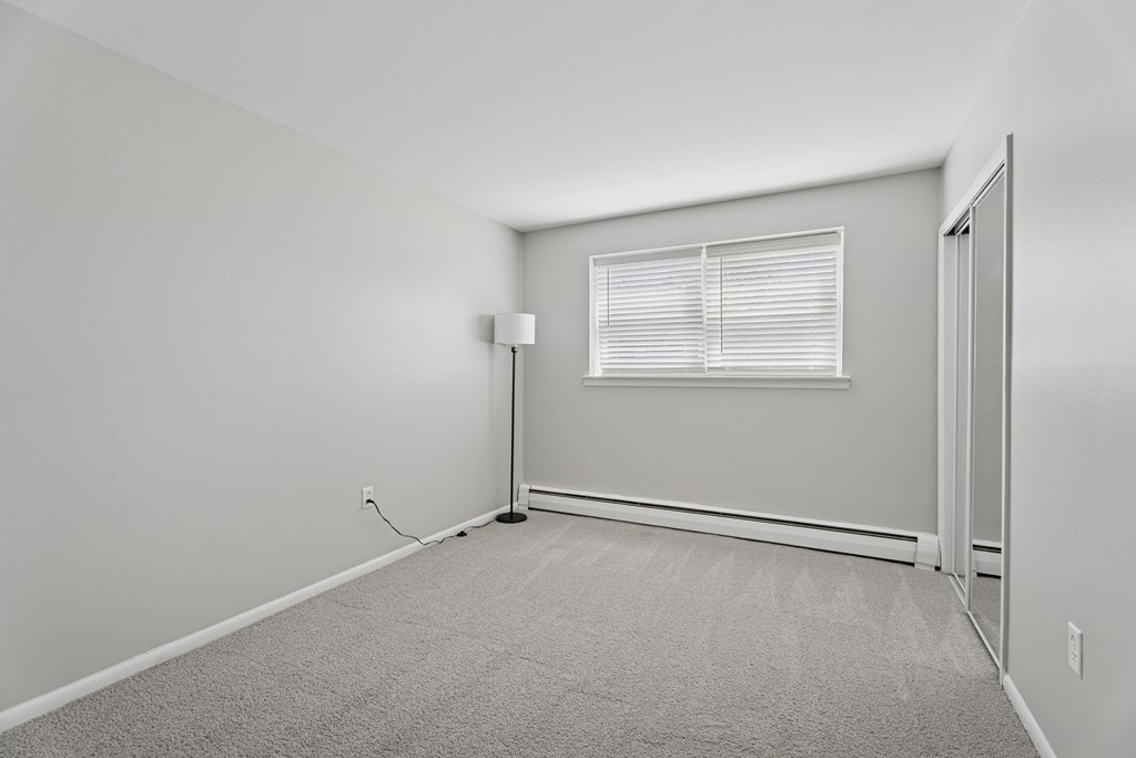 A room with a window and a door.