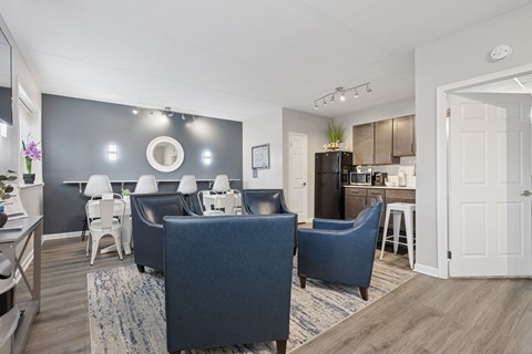 A living room with a grey couch and a white chair.