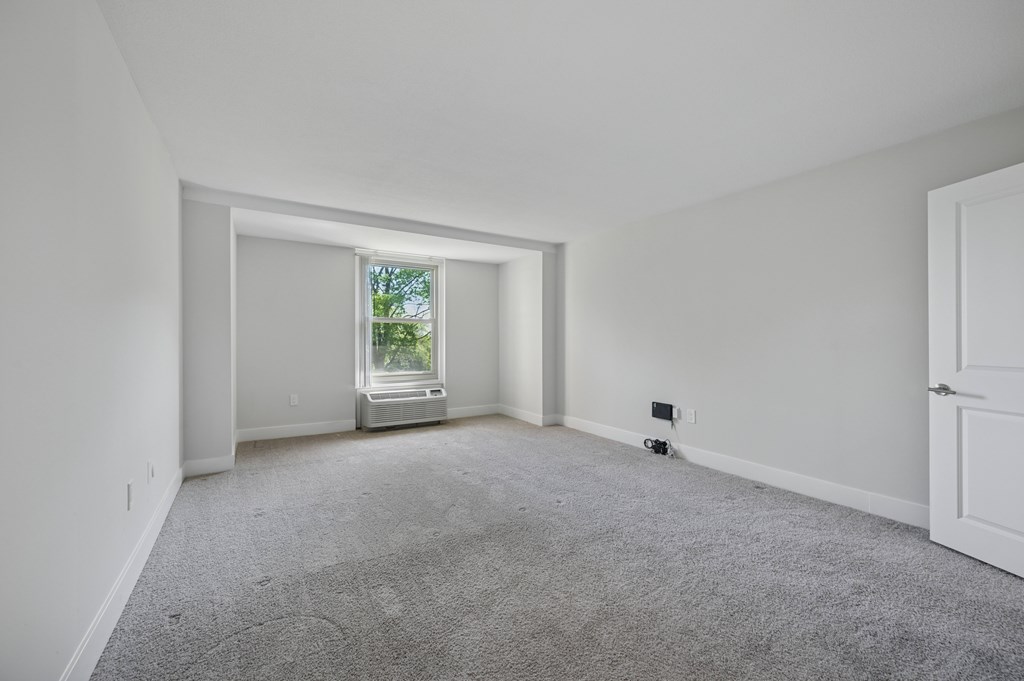 A room with a window and a door.