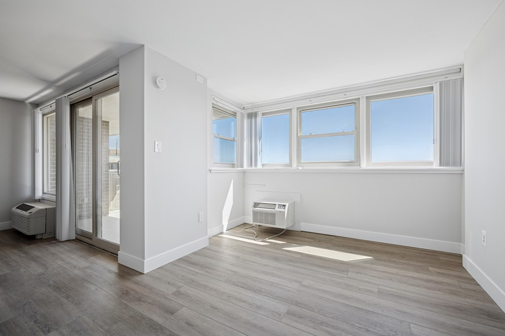 A room with a sliding glass door and a window.