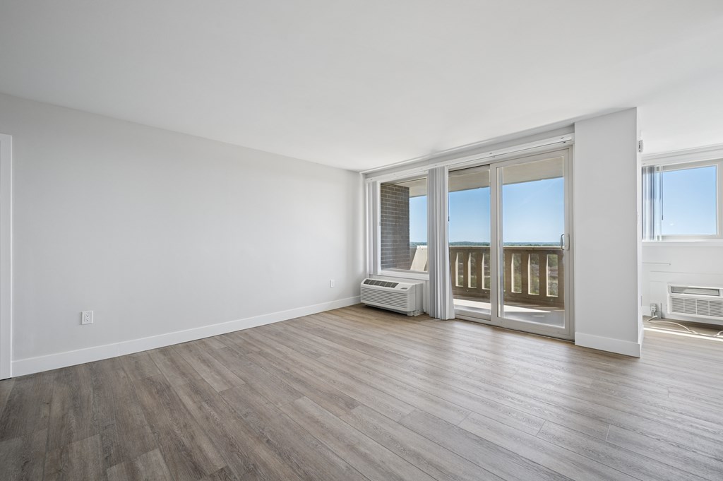 A room with a sliding glass door and a window.