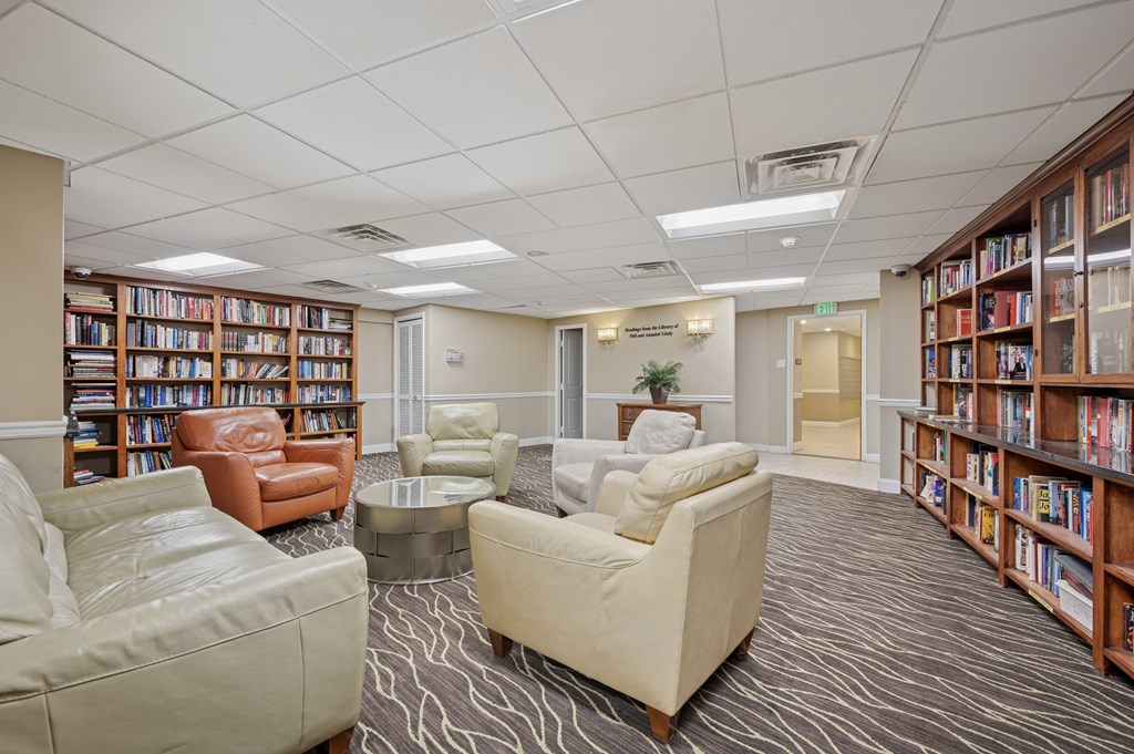 A library with leather and fabric chairs and tables.