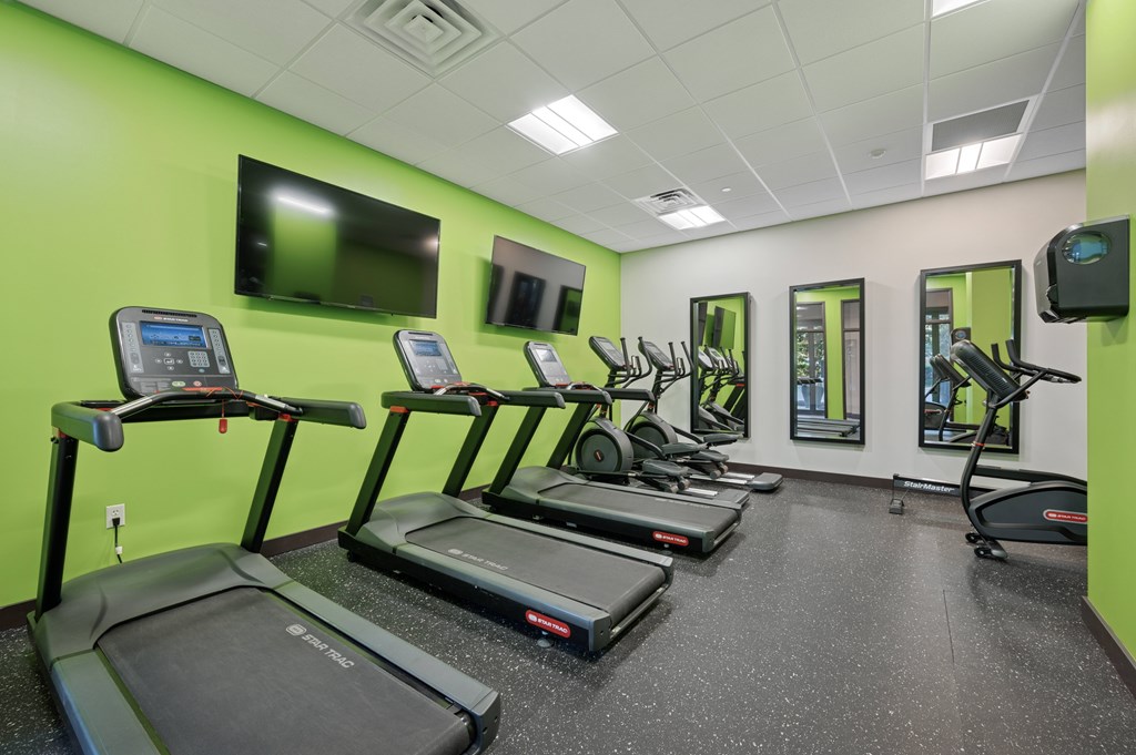 A gym with treadmills and exercise equipment.