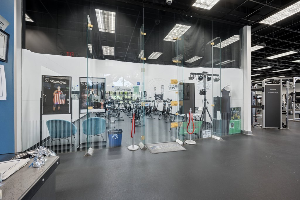 A gym with a variety of equipment and a poster on the wall.