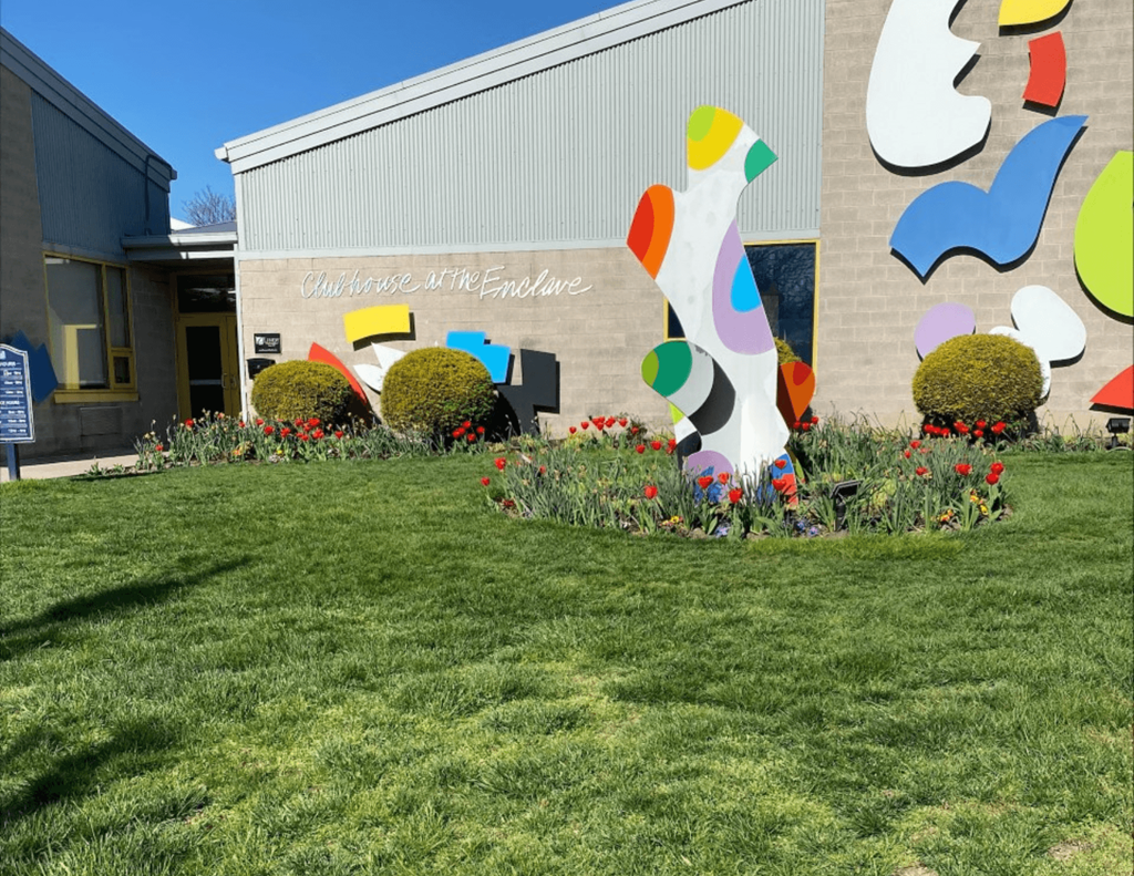 a large colorful sculpture in front of a building
