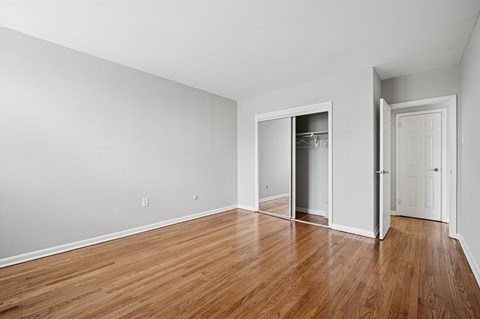 A room with wooden floors and white walls.