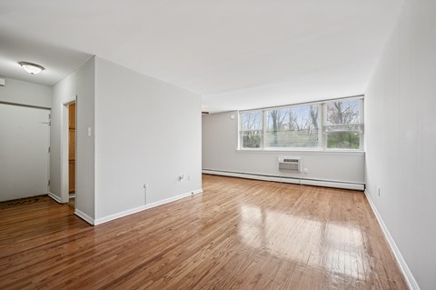 A room with wooden floors and white walls.