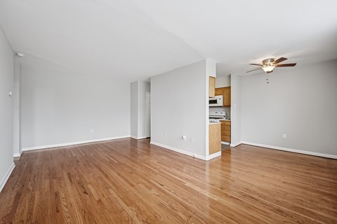 A room with wooden floors and a ceiling fan.
