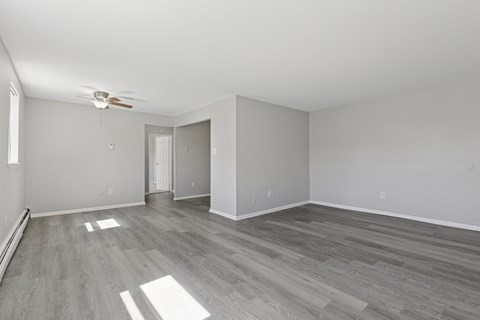 A room with a ceiling fan and light fixture.