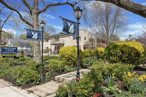 A sign for Westgate Apartments is displayed in front of a building.
