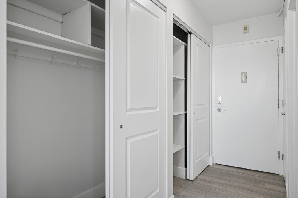 A white door is open to a hallway.