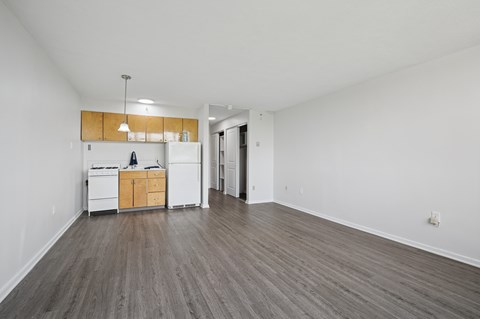 A kitchen with white appliances and wooden cabinets is in the image.