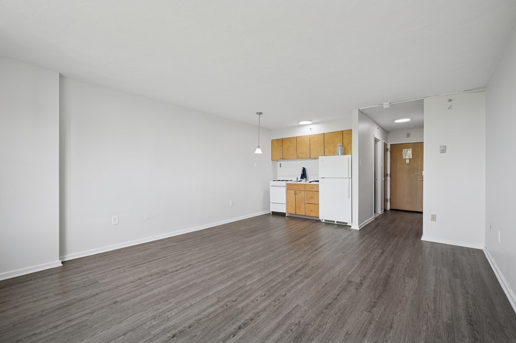 A kitchen area with white cabinets and a wooden island.