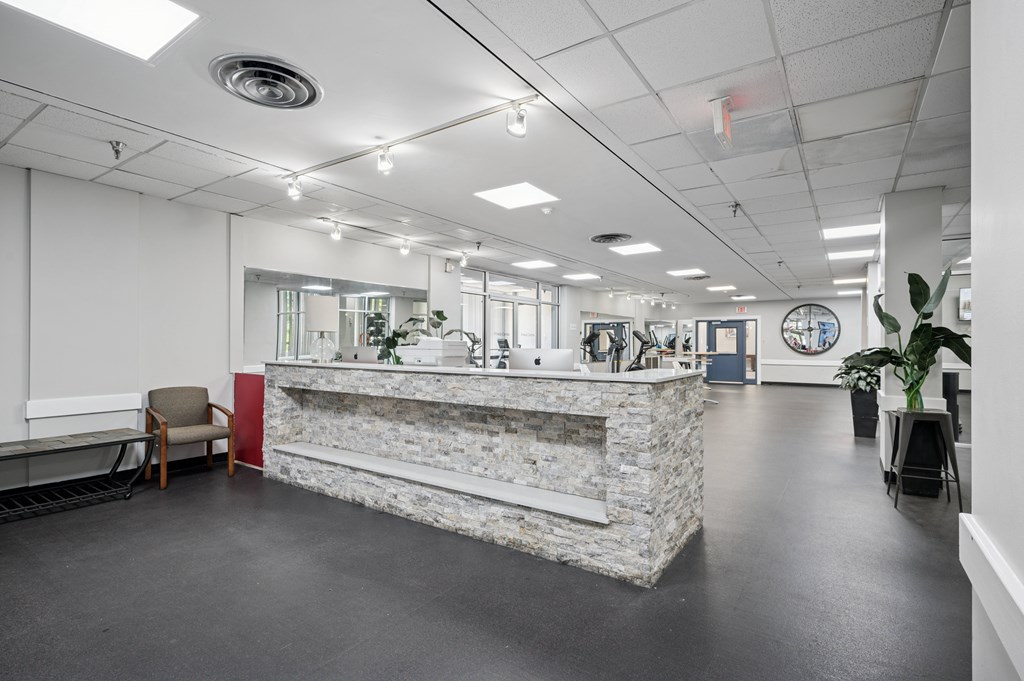 A reception area with a stone counter and a plant.