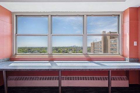 A window with a view of a cityscape and a building.