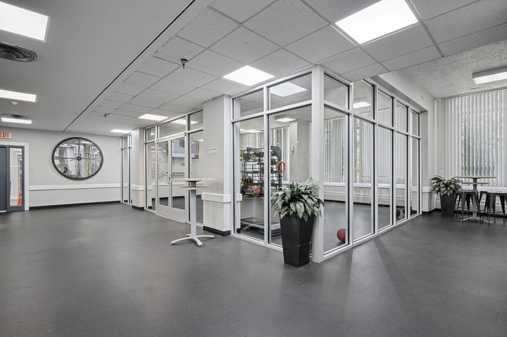 A large open office space with glass walls and a basketball on the floor.