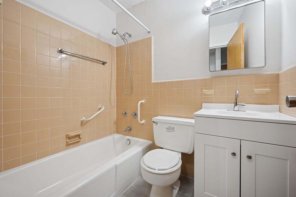 A bathroom with a white toilet, sink, and bathtub.