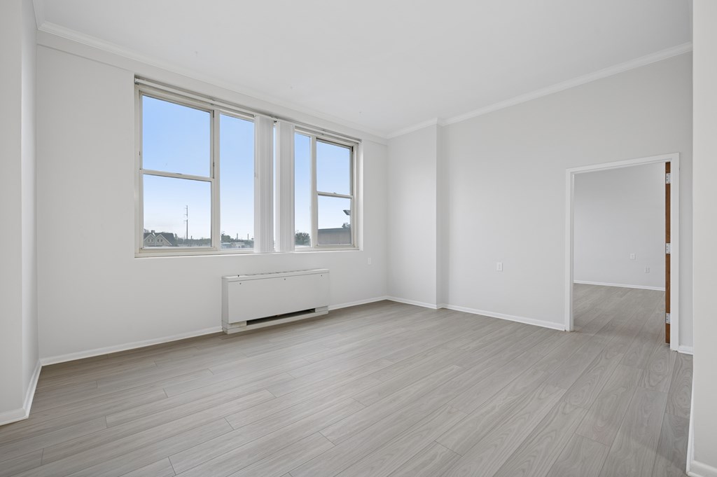 A room with a window and a radiator on the wall.