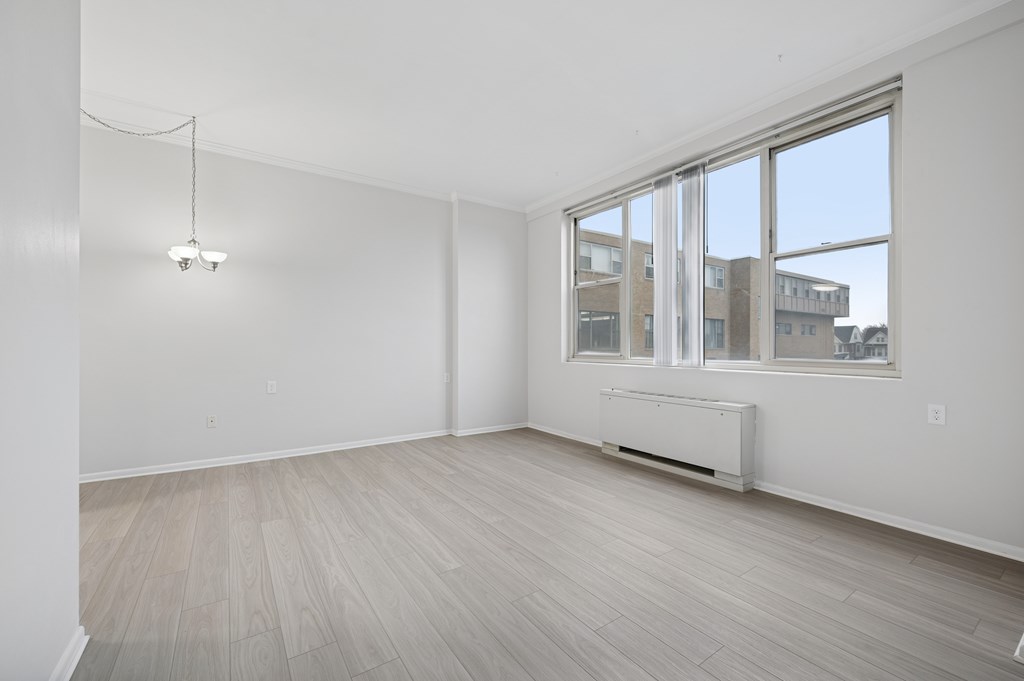 A room with a window and a radiator on the wall.
