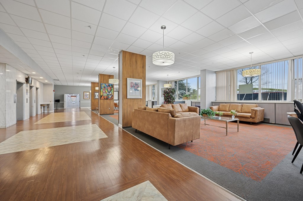 A spacious living room with a long wooden table and a couch.