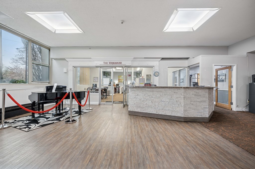 A reception area with a piano and a reception desk.