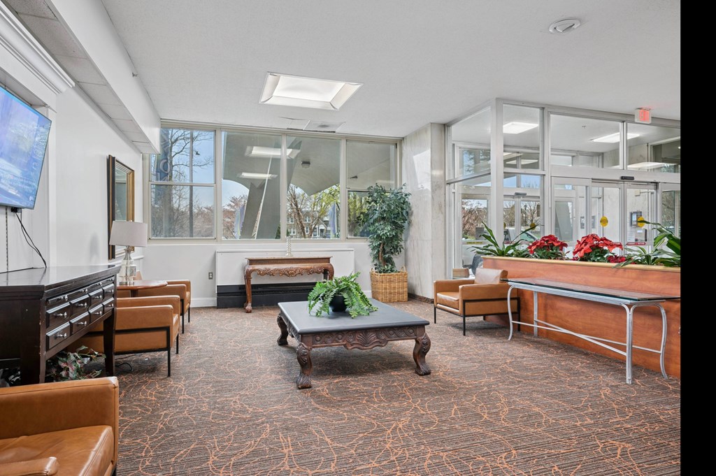 A conference room with a long table and chairs.