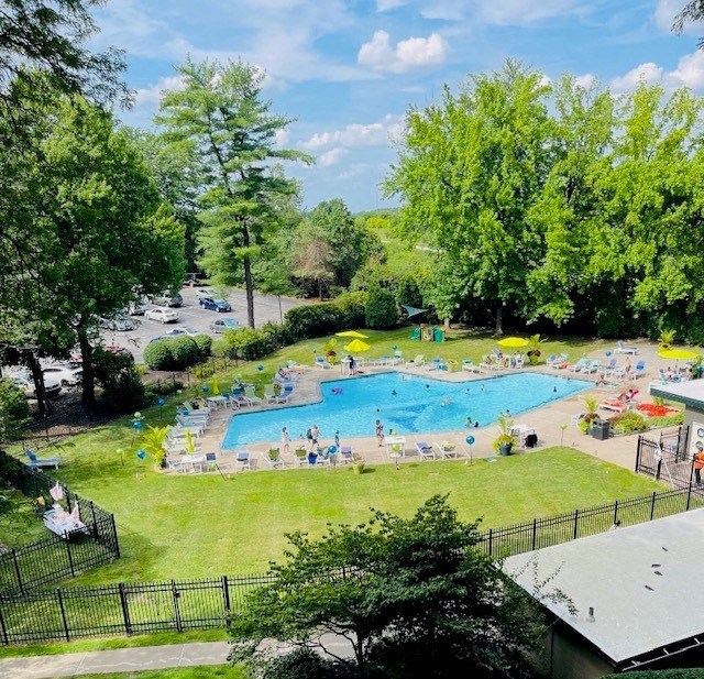 a large grassy area with a pool in the middle of it
