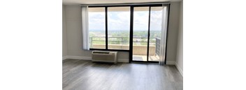 an empty living room with sliding glass doors and a balcony