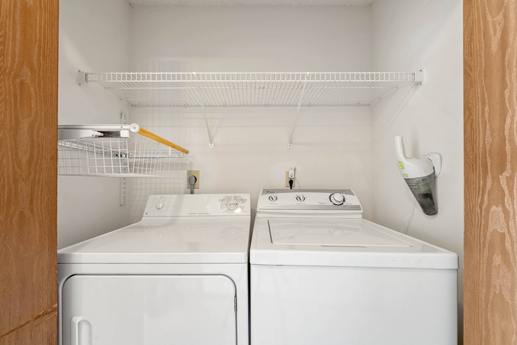 A small laundry room with a washer and dryer.