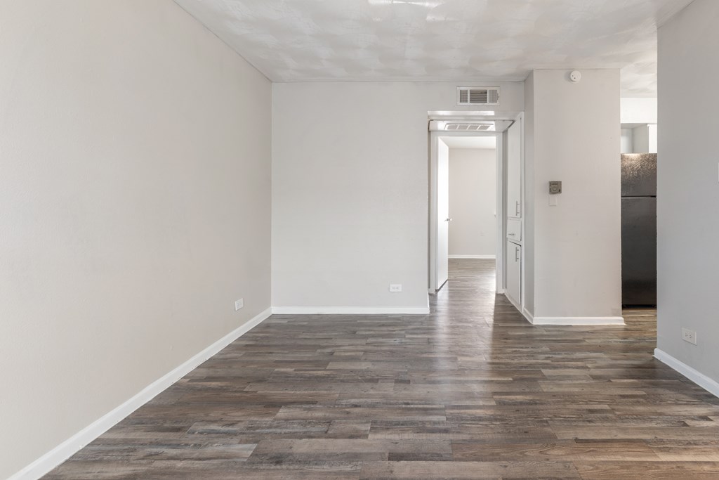 A room with a wooden floor and white walls.