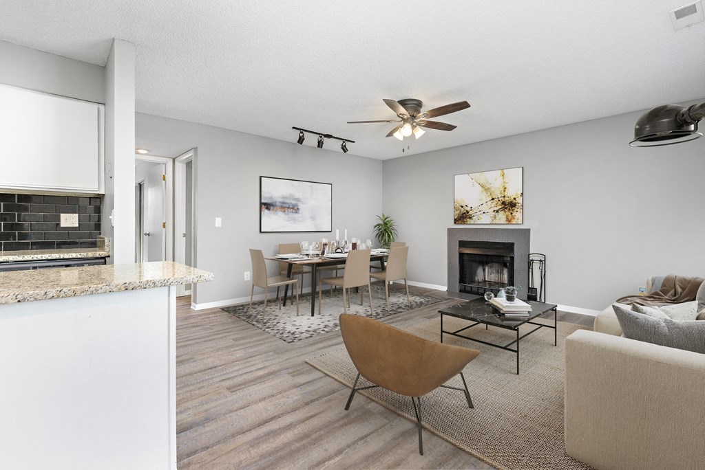 Living room with chair, table, and fireplace at Eddingham in Lawrence, KS