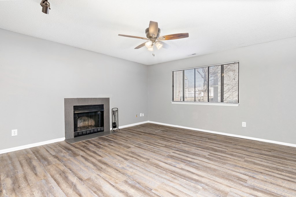 Living room with fireplace and wall art at Eddingham in Lawrence, KS