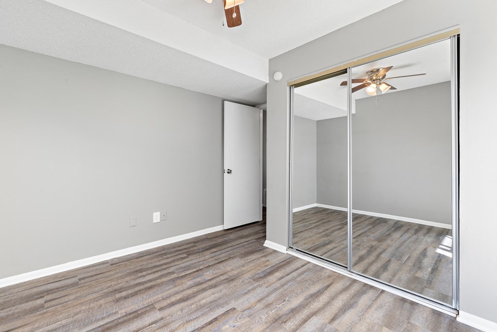 Bedroom with large closet mirror door at Eddingham in Lawrence, KS