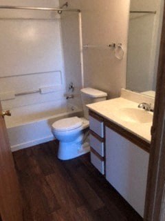 bathroom with vanity, toilet and tub