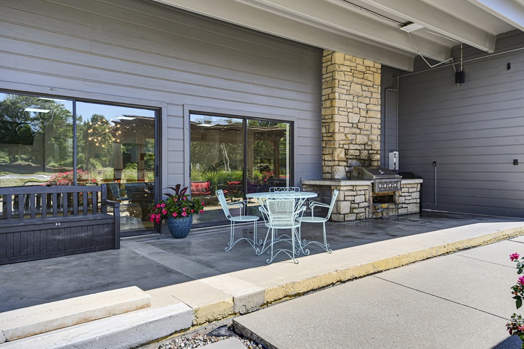Clubhouse with seating area and gas grill at fairway hills apartments