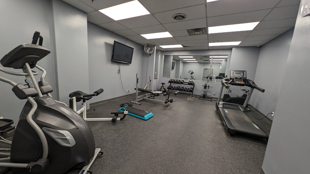 a gym with various exercise equipment in a building