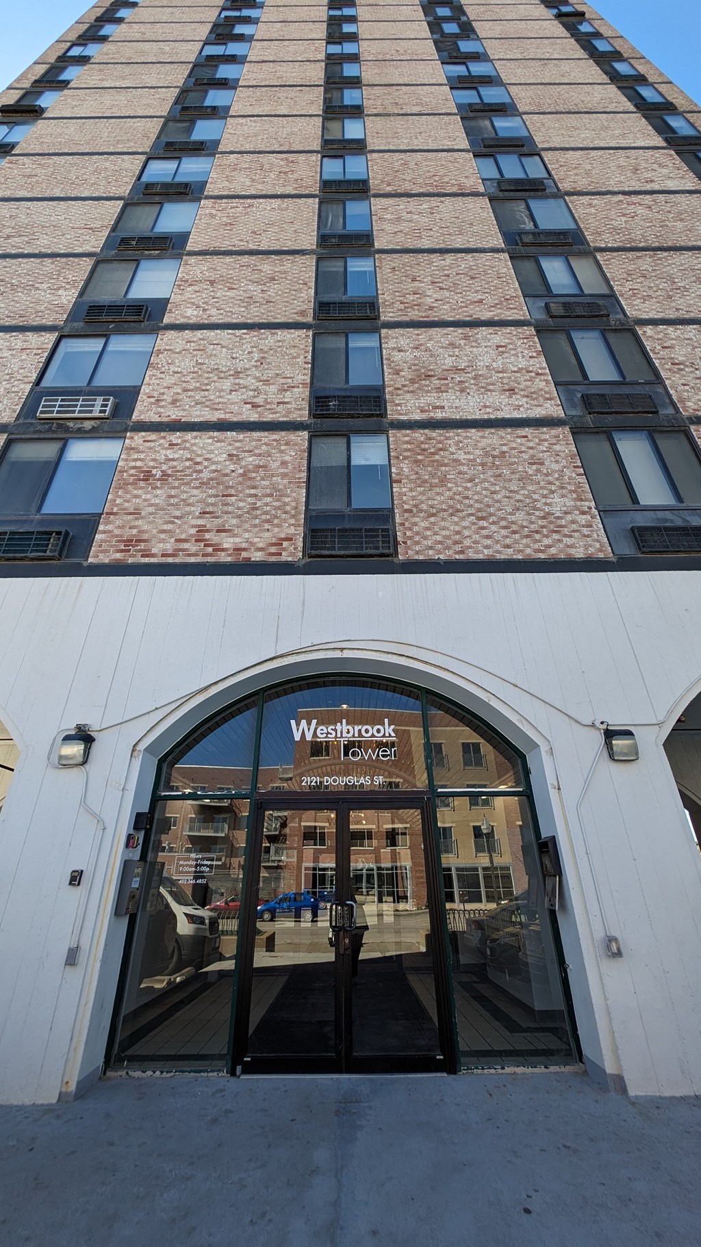 a view of the front of a building with a sign in the front door