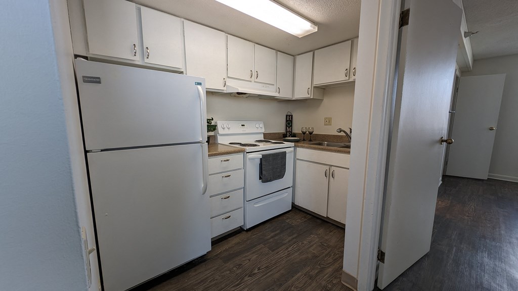 a kitchen with white appliances and white cabinets