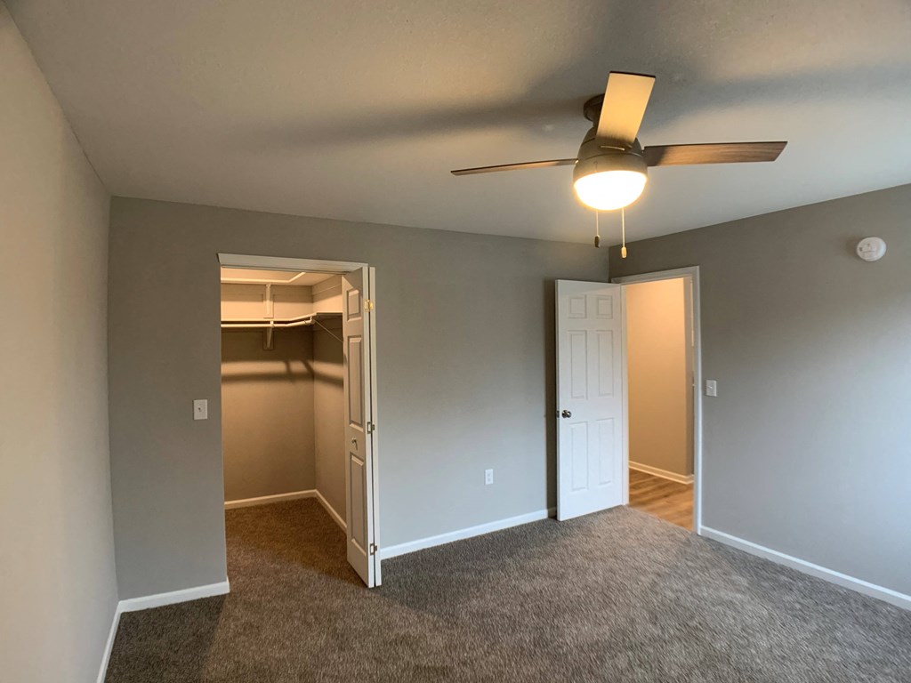 large bedroom with carpet and closet