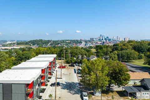 A view of a city skyline from a distance with a parking lot in the foreground.