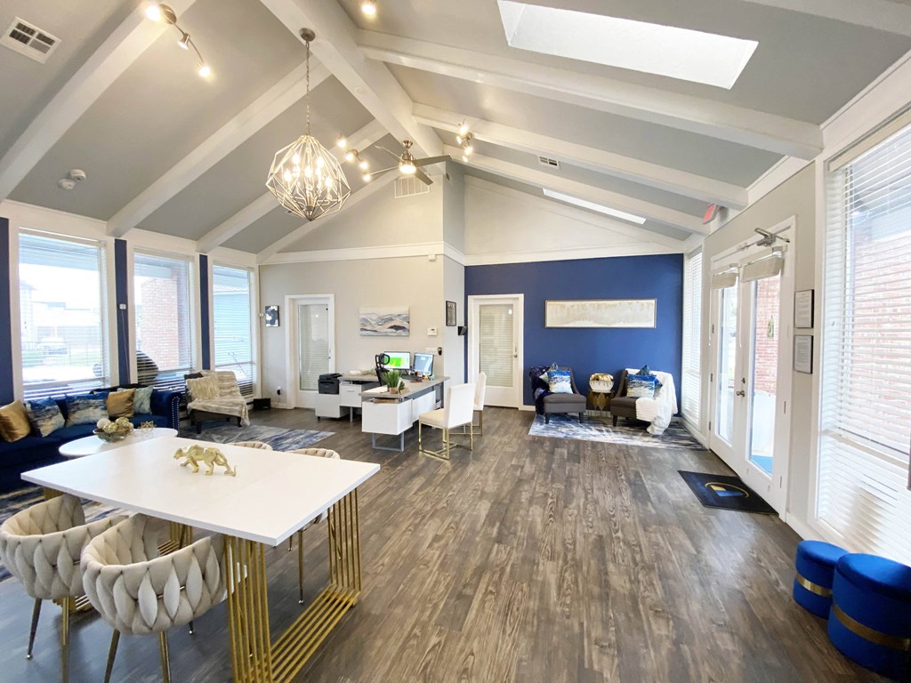 a living room with blue walls and a white table and chairs