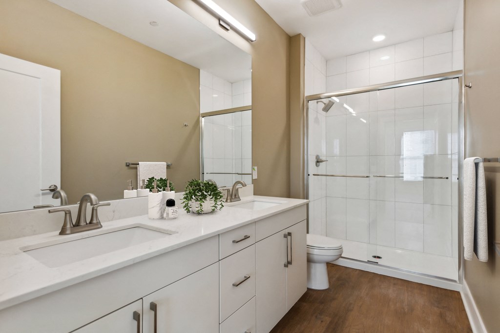 a bathroom with a sink and a shower and a toilet