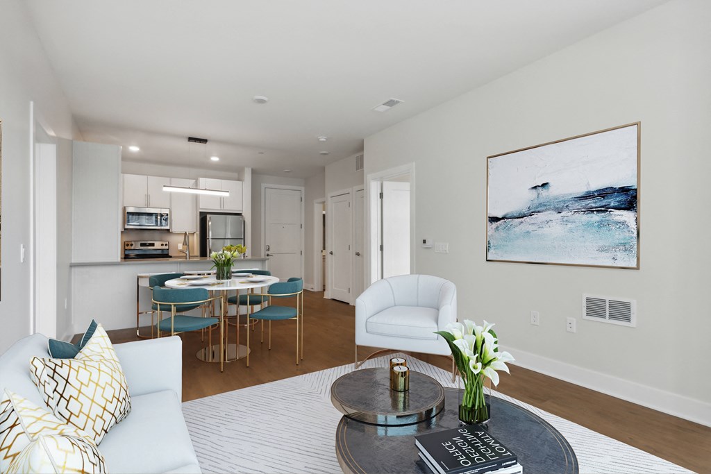 a living room with a couch and a table and a kitchen