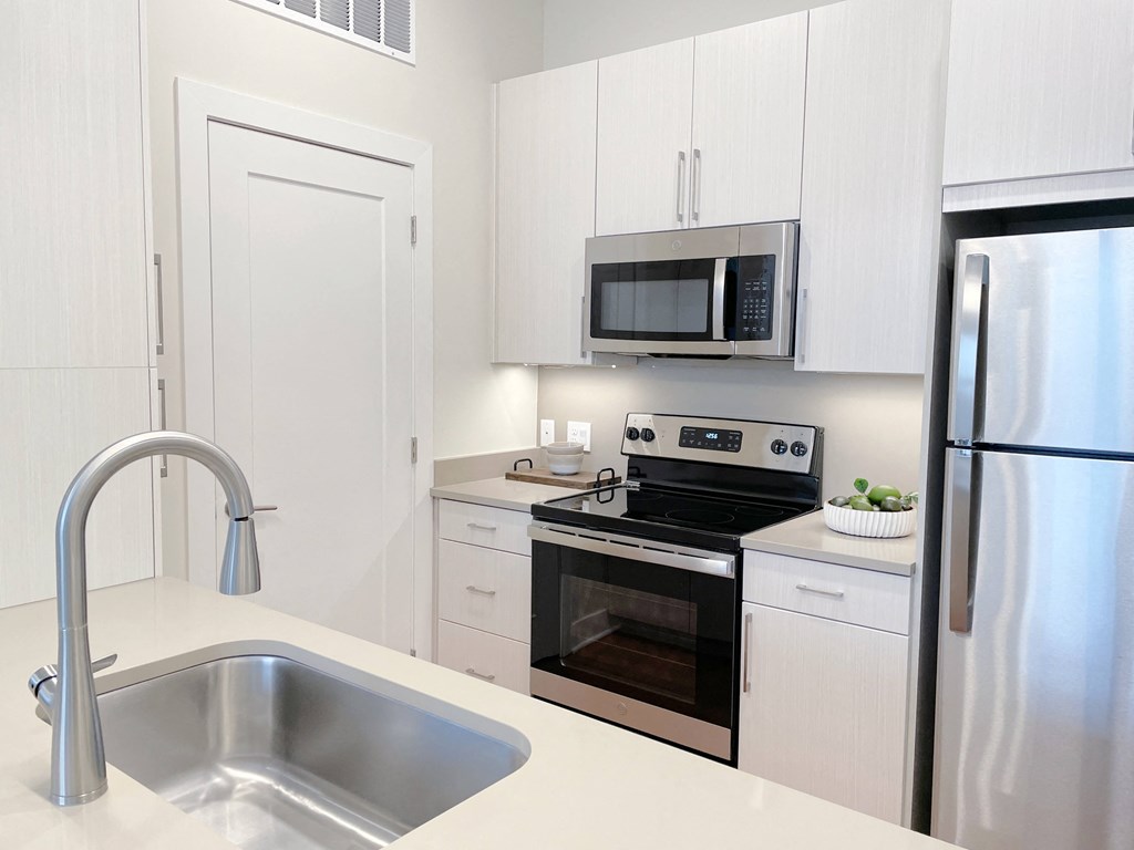 a kitchen with stainless steel appliances and a sink