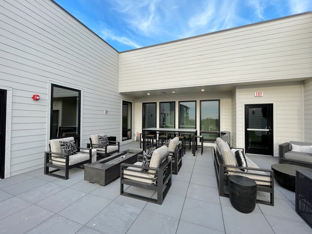 the outdoor patio has seating and a fire pit